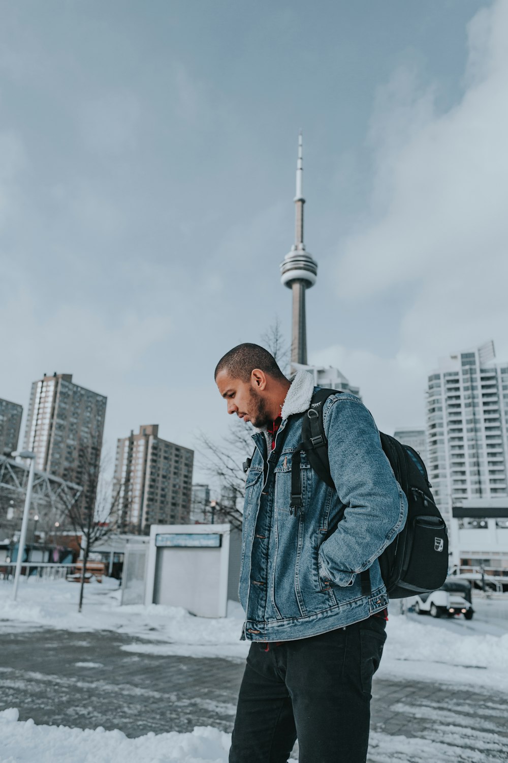 a man with a backpack standing in the snow