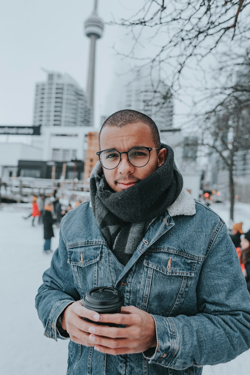 A man wearing glasses and a scarf holding a camera photo – Free Toronto  Image on Unsplash