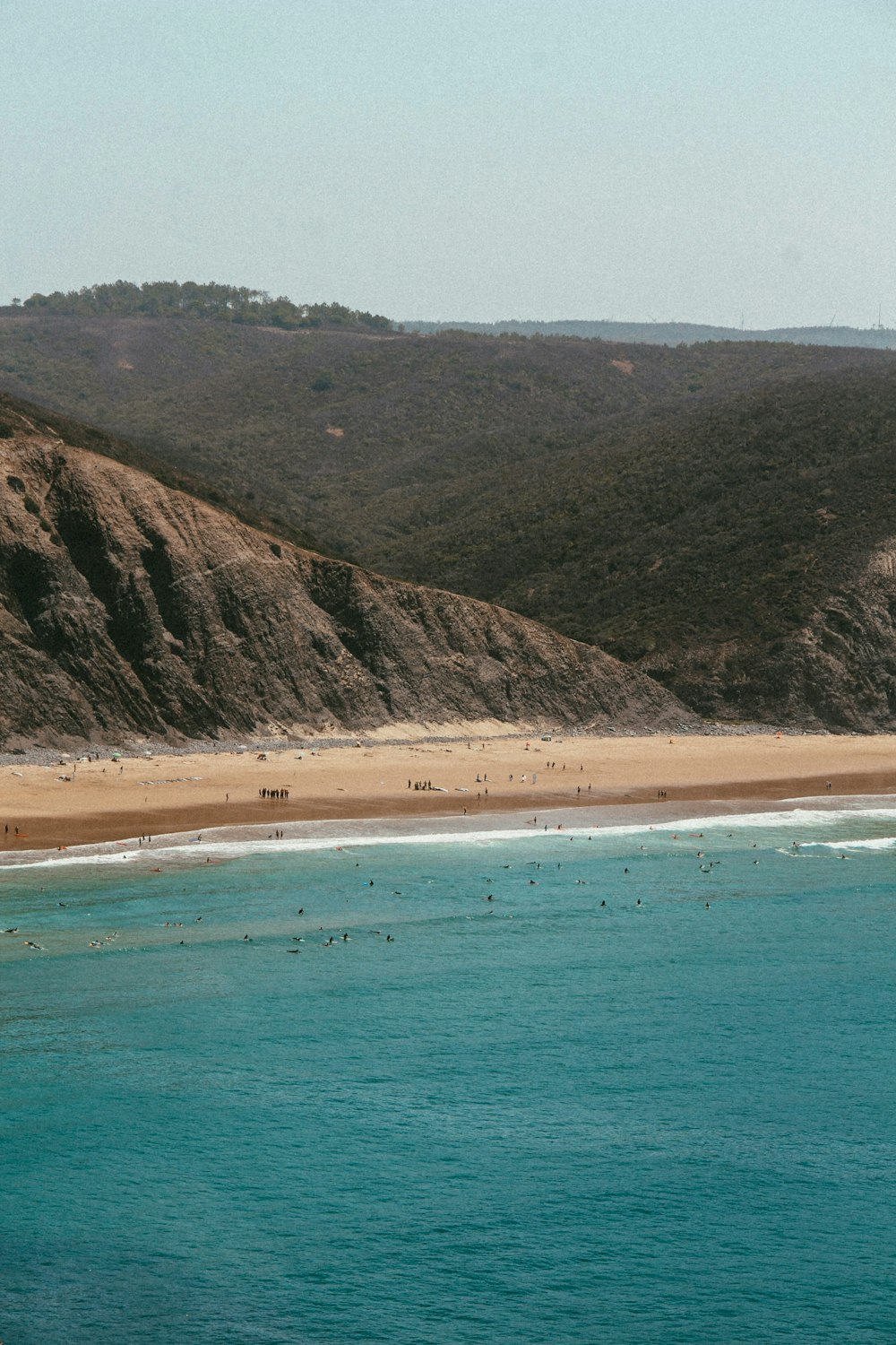 a view of a beach with a mountain in the background