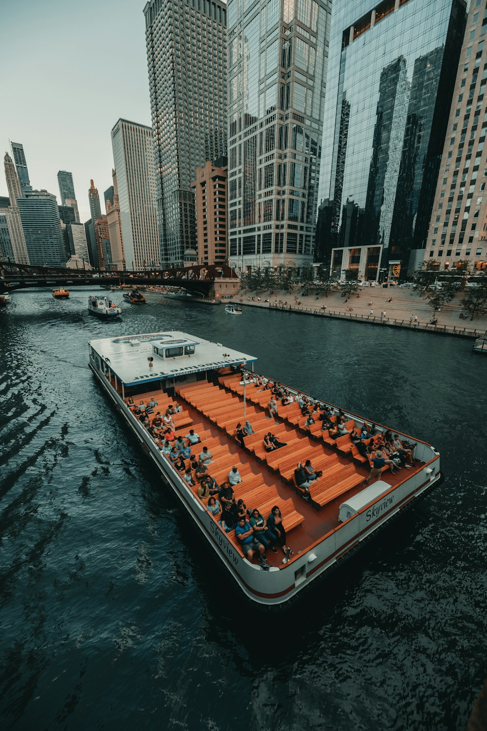 a large boat floating on top of a river next to tall buildings