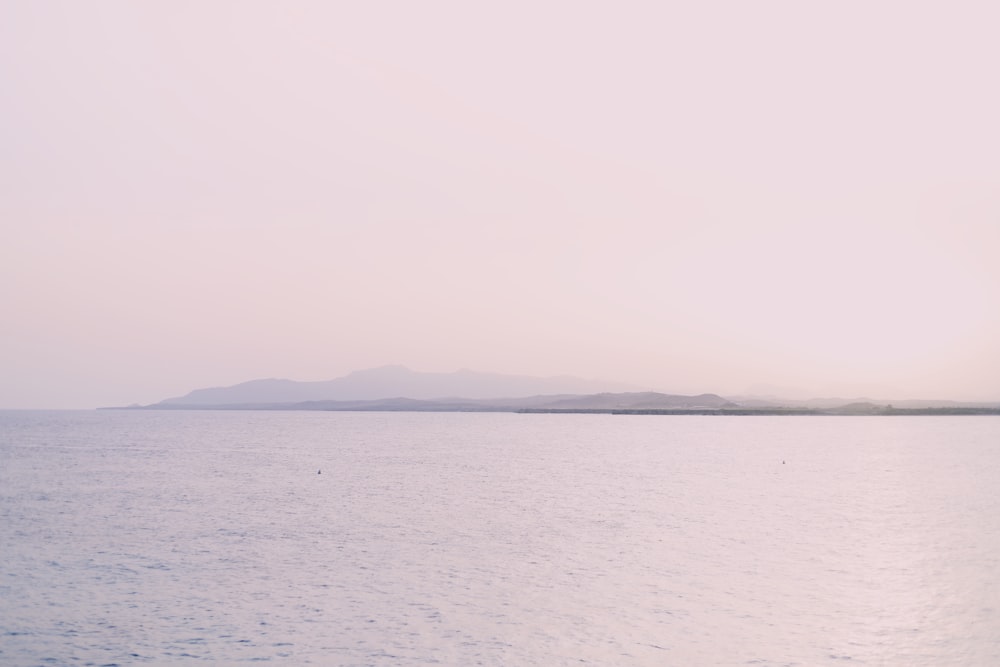 a large body of water with a small island in the distance