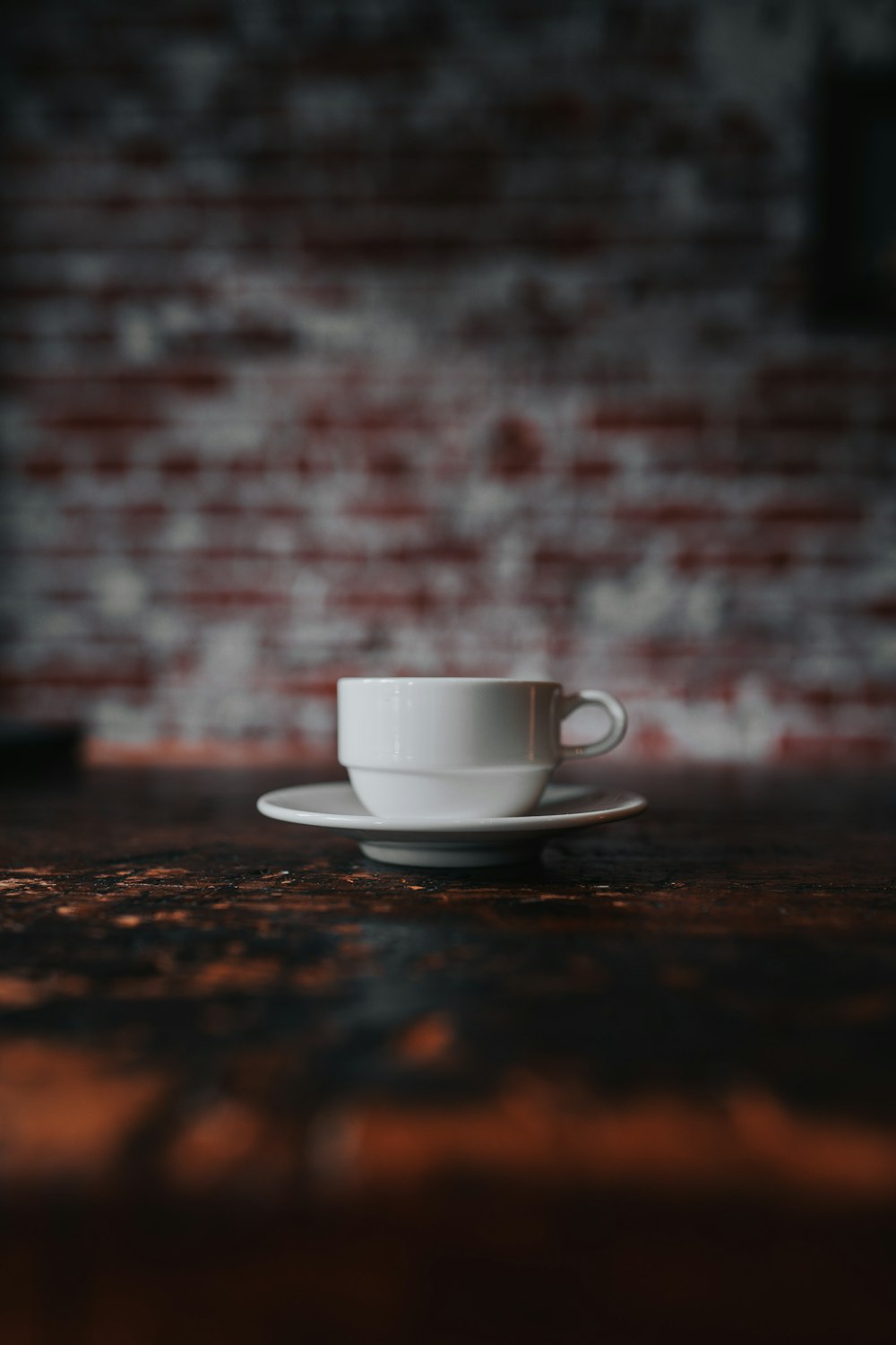 a white coffee cup sitting on top of a wooden table