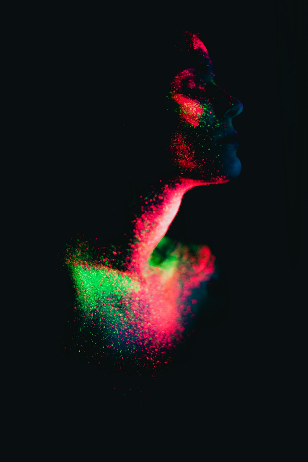 a woman's face is lit up with colored powder