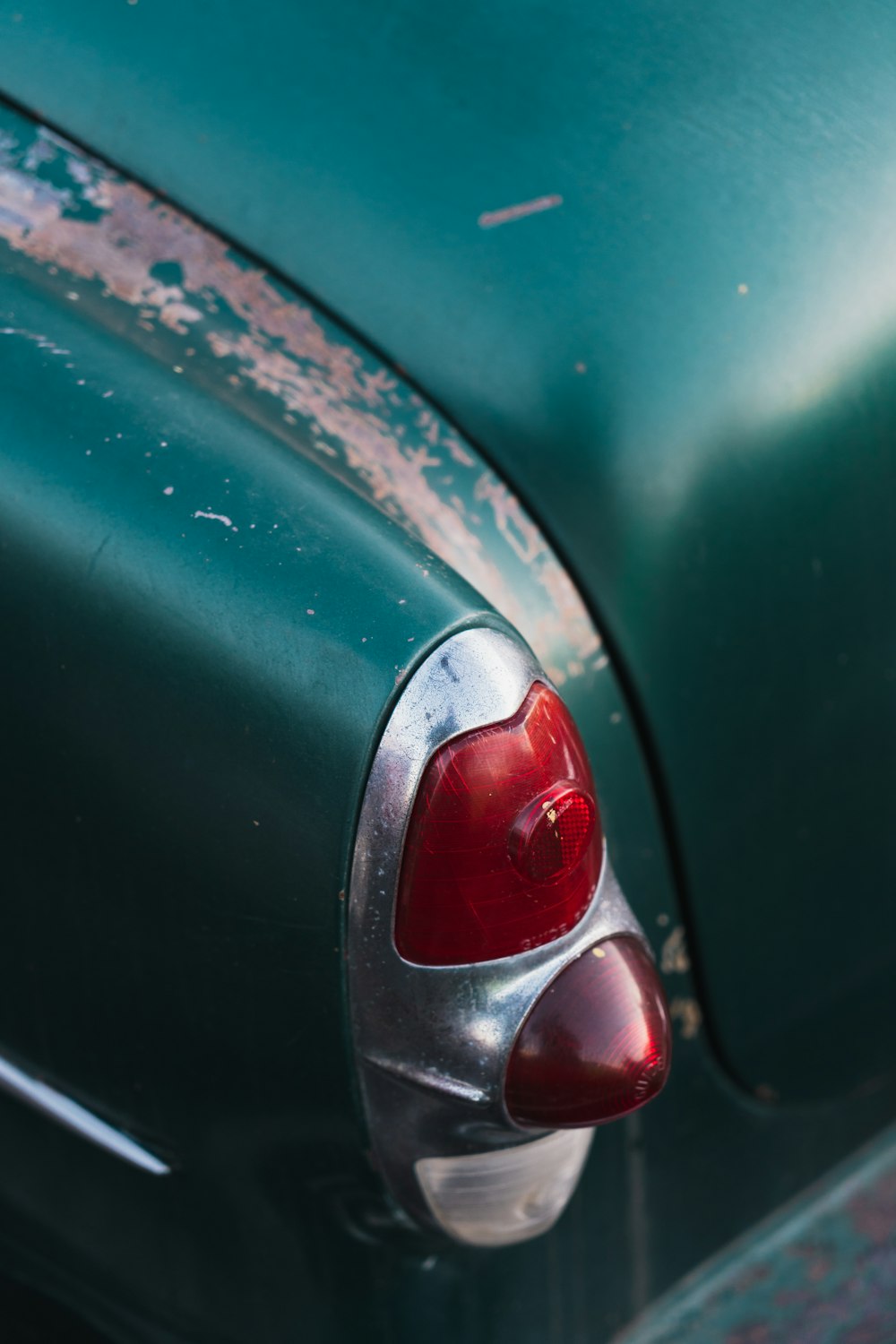 a close up of the tail end of a green car