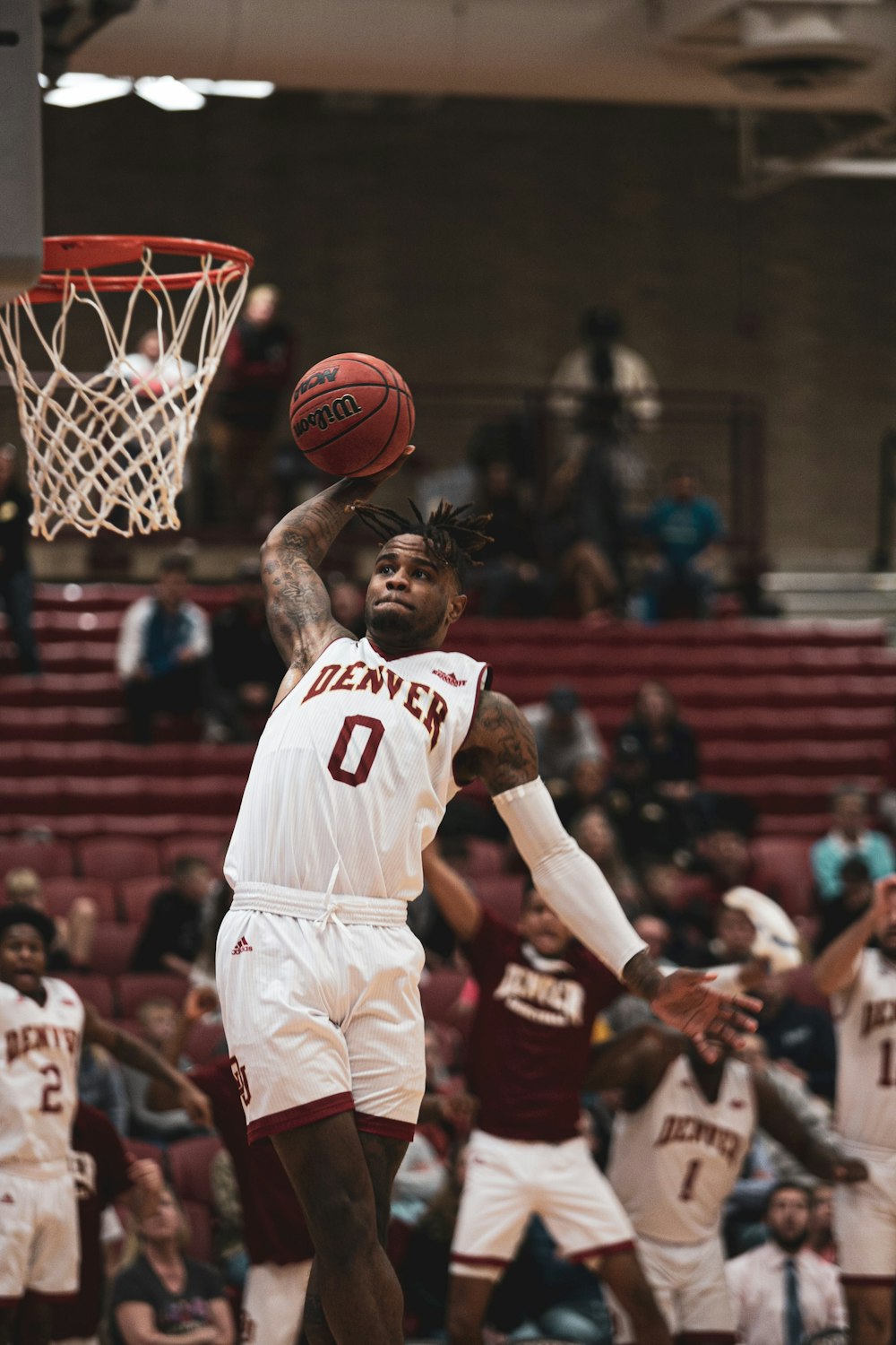 a man dunking a basketball in front of a crowd