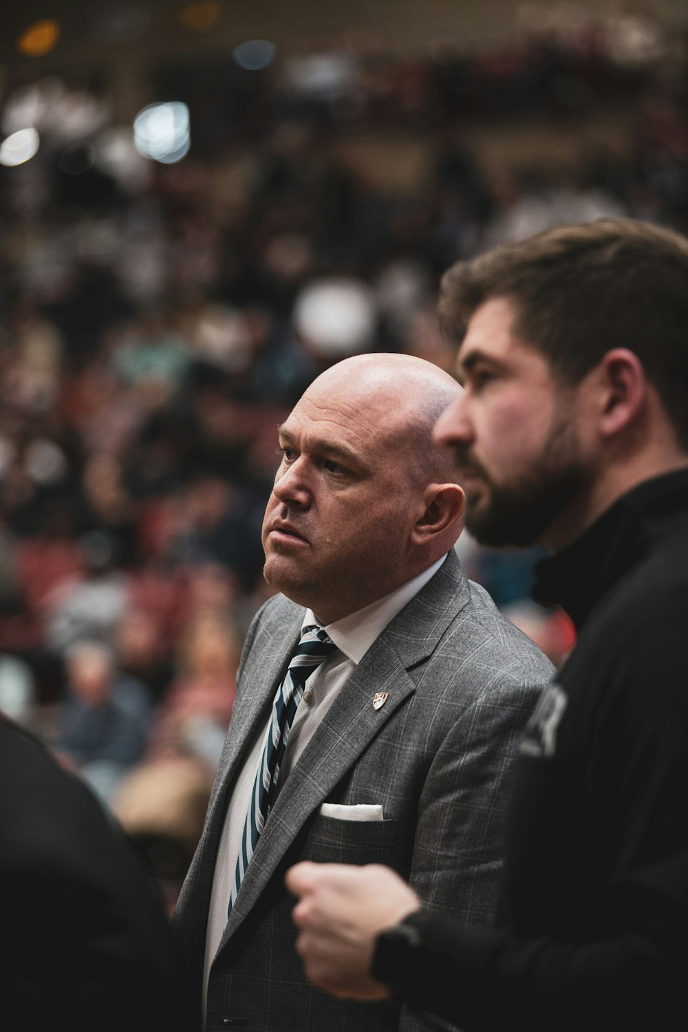 a man in a suit and tie standing next to another man