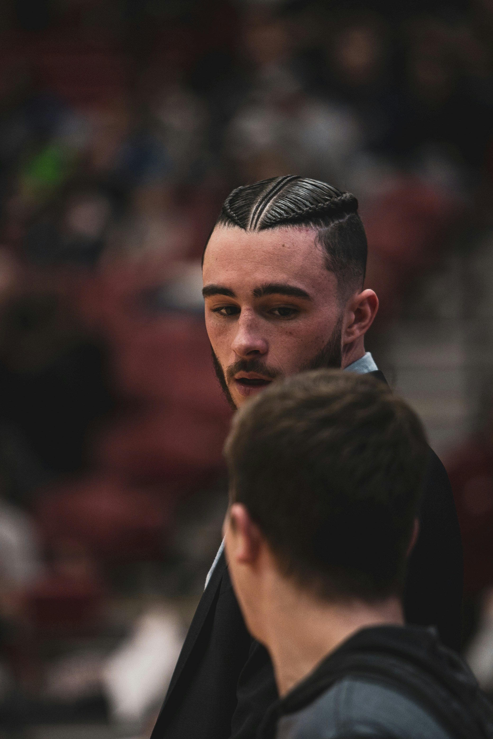A man in a suit standing next to another man photo – Free Human Image