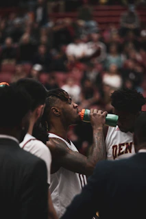 Athlete taking a quick hydration break with an electrolyte drink between rounds.