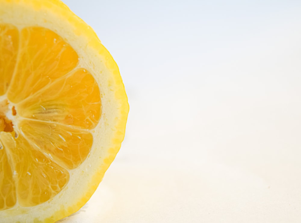 yellow lemon fruit on white surface