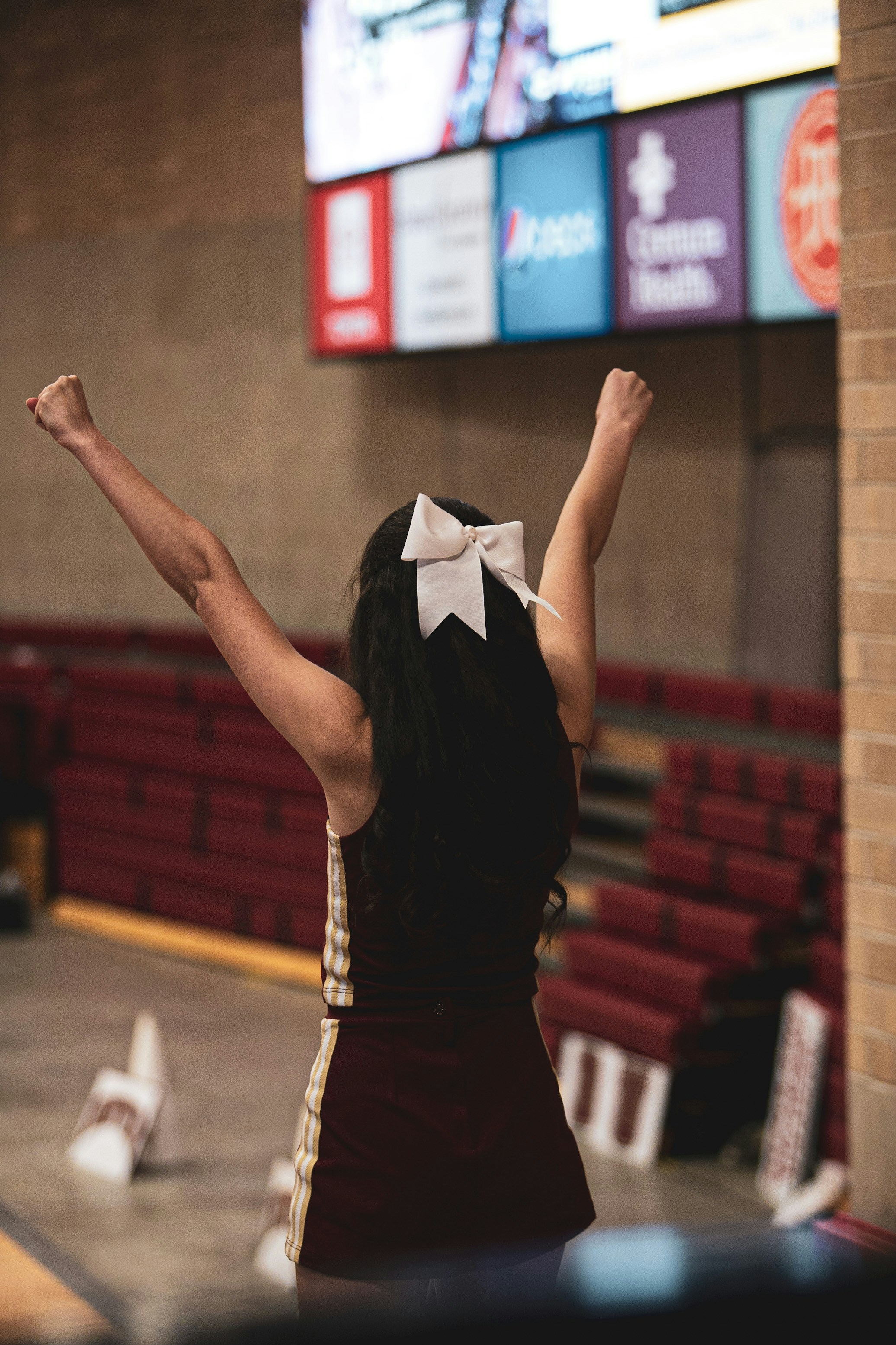 a woman with her arms in the air in a gym