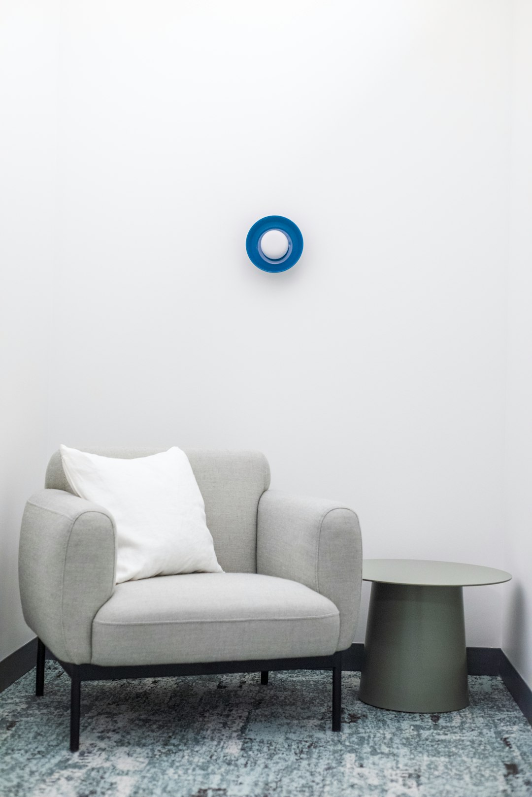  blue round ball on grey sofa armchair