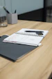 black ipad on brown wooden table