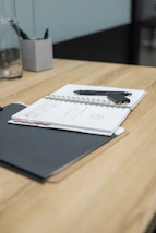 black ipad on brown wooden table