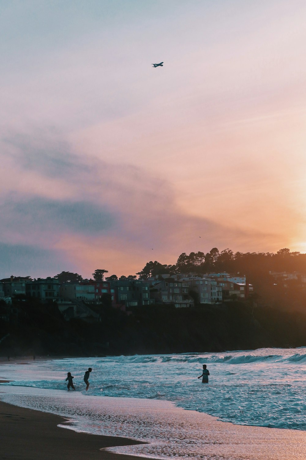 silhouette of person surfing on sea during sunset