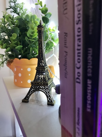 A cozy study corner with French books, a laptop, and a small Eiffel Tower figurine.