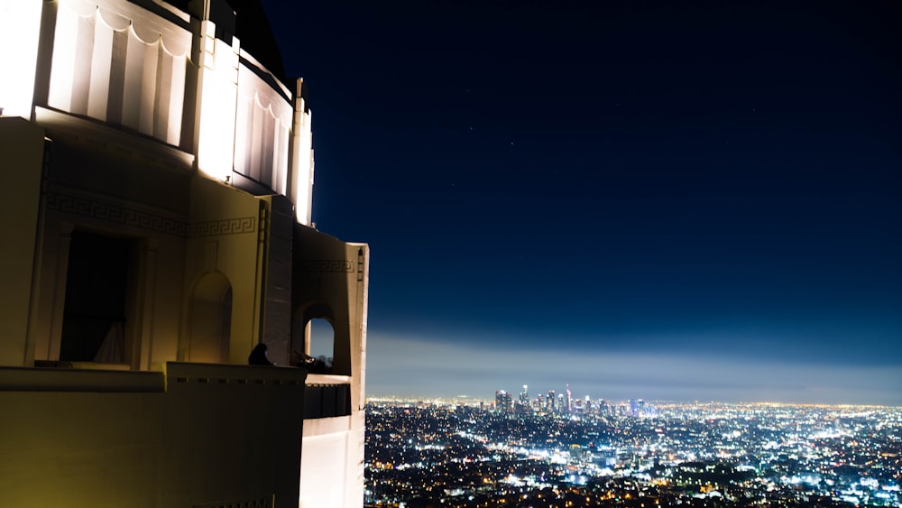 a view of a city at night from the top of a building