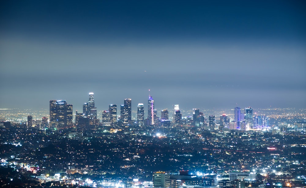 a view of a city at night from the top of a hill