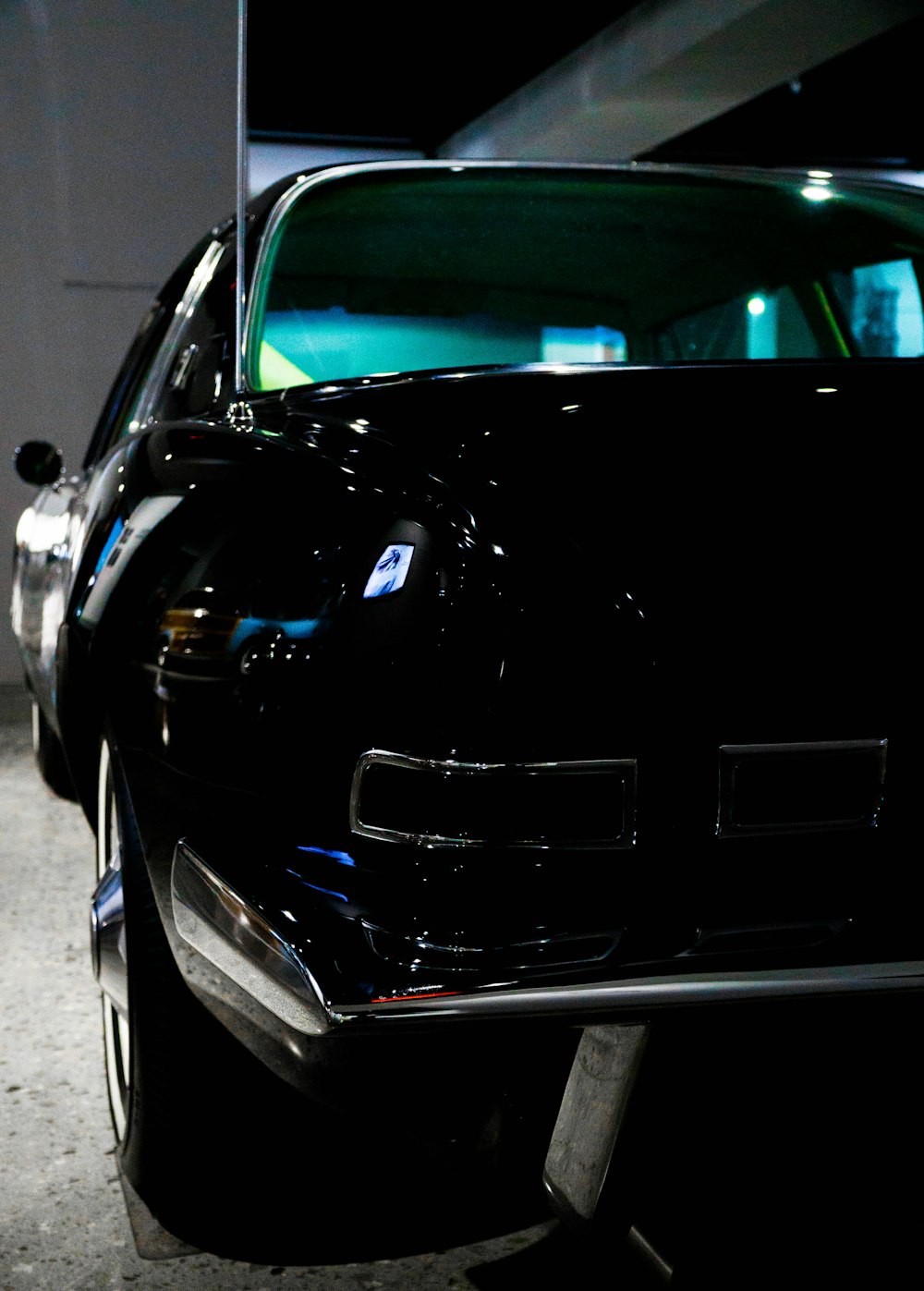 a black car parked in a parking garage