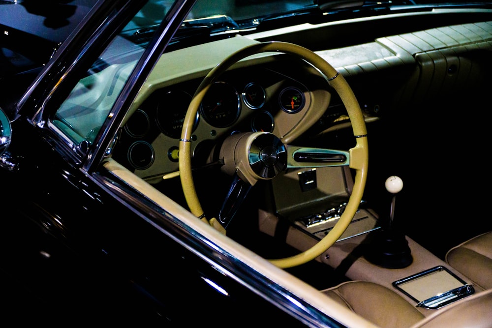 the interior of a car with a steering wheel and dashboard