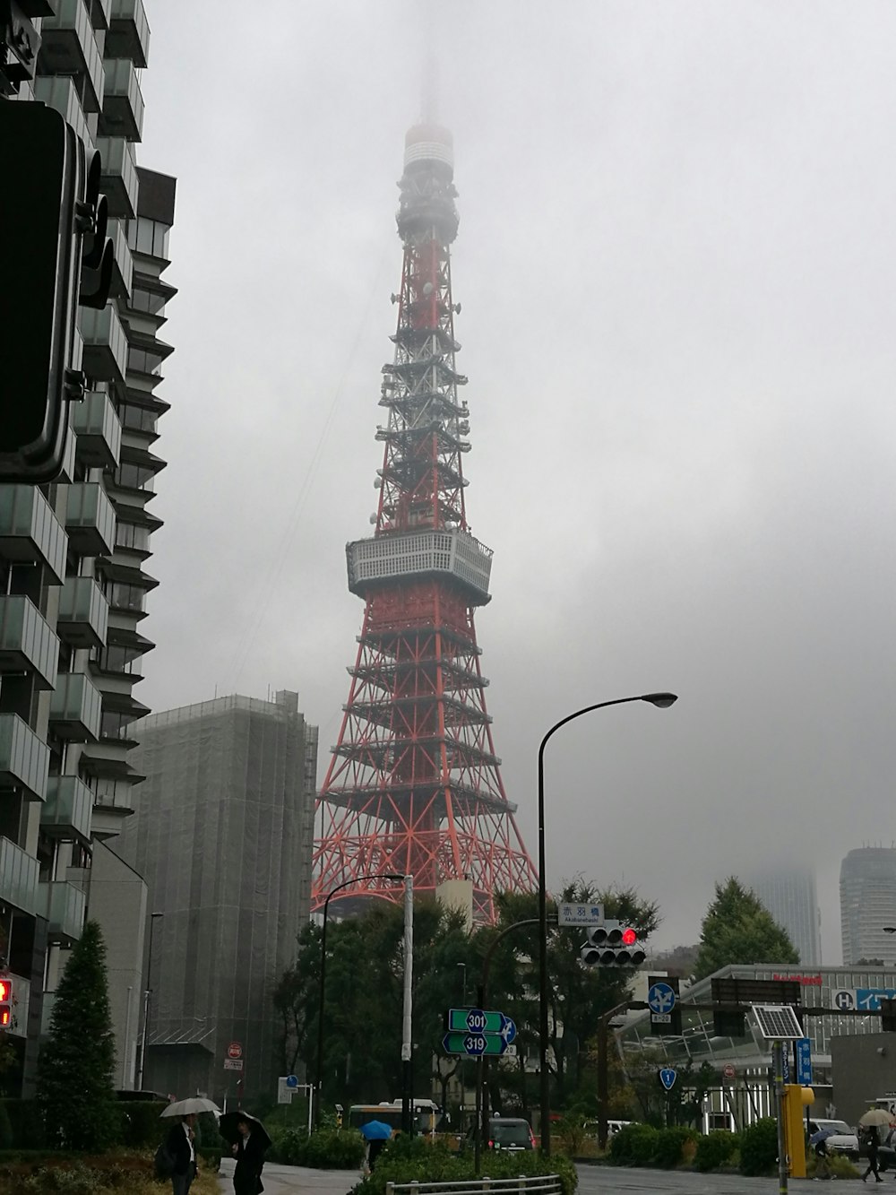 red and white tower under white clouds during daytime