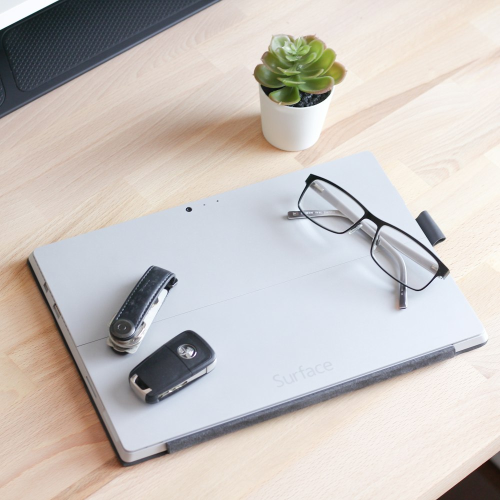 black framed eyeglasses on white laptop computer