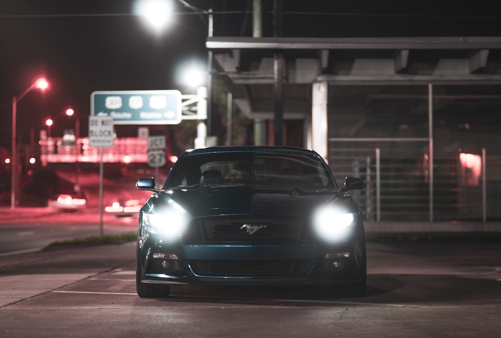 a car parked on the side of the road at night