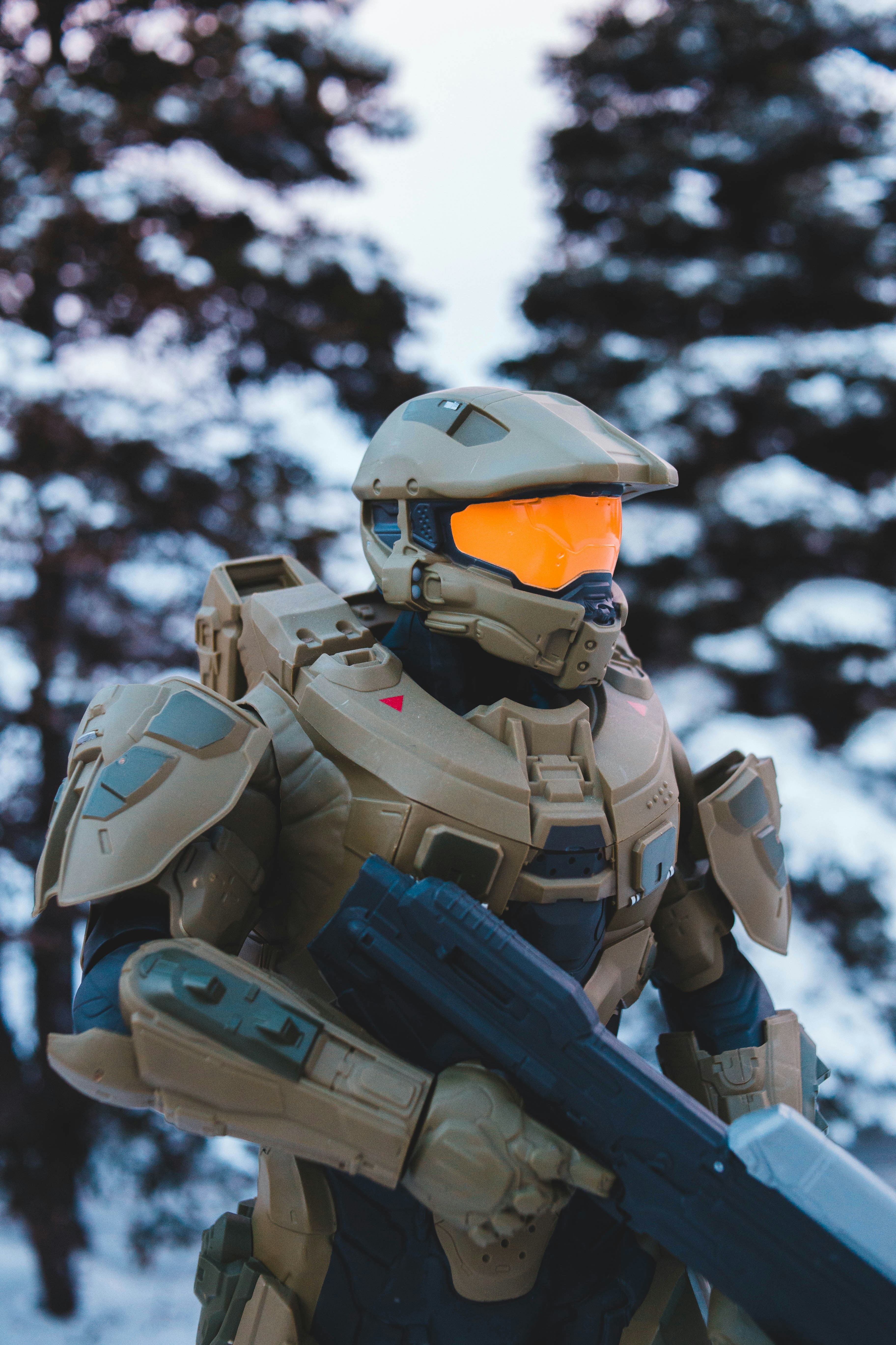 a man in a futuristic suit holding a rifle