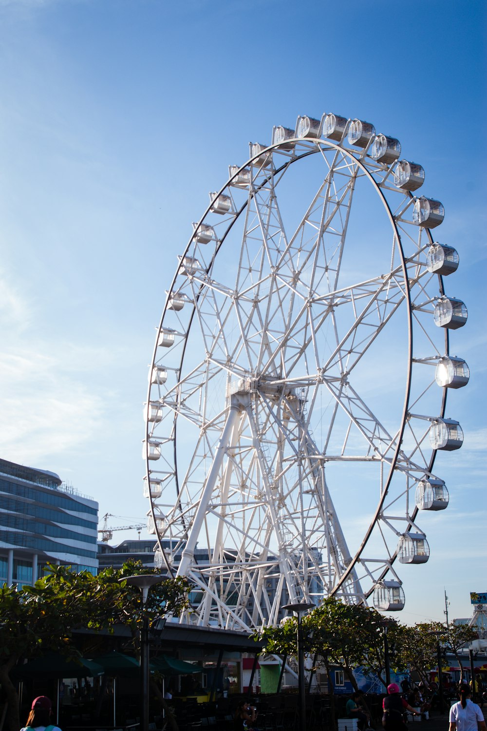 white ferris wheel near white building during daytime