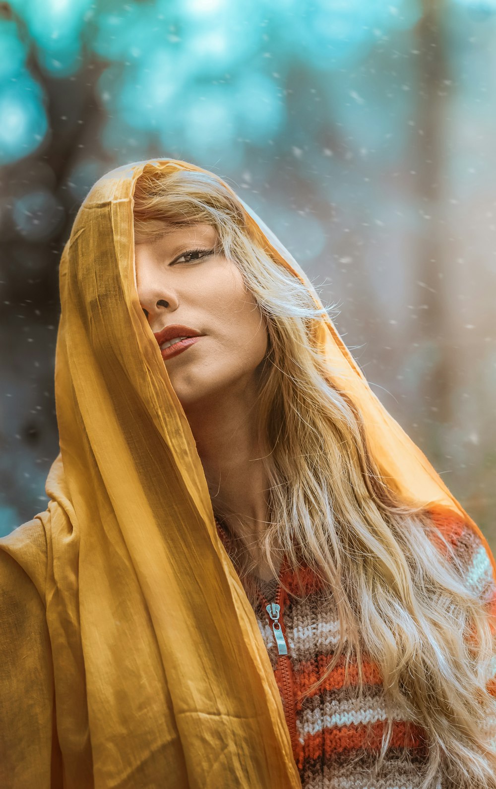 a woman wearing a yellow shawl in the rain
