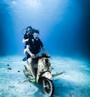 man in black and white suit riding motorcycle