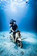 man in black and white suit riding motorcycle
