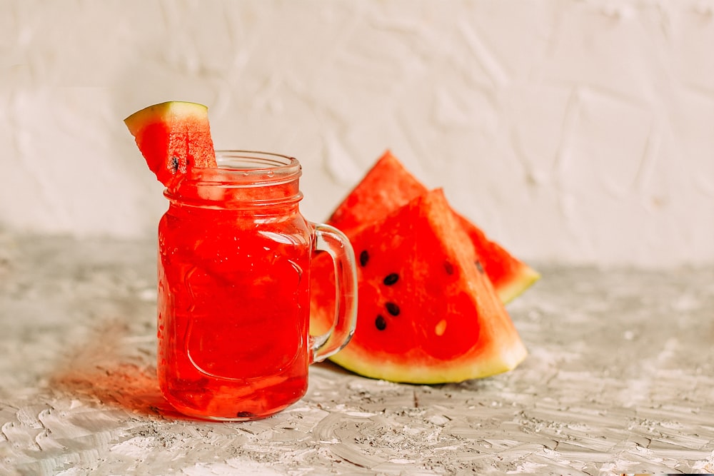 clear glass jar with red liquid inside