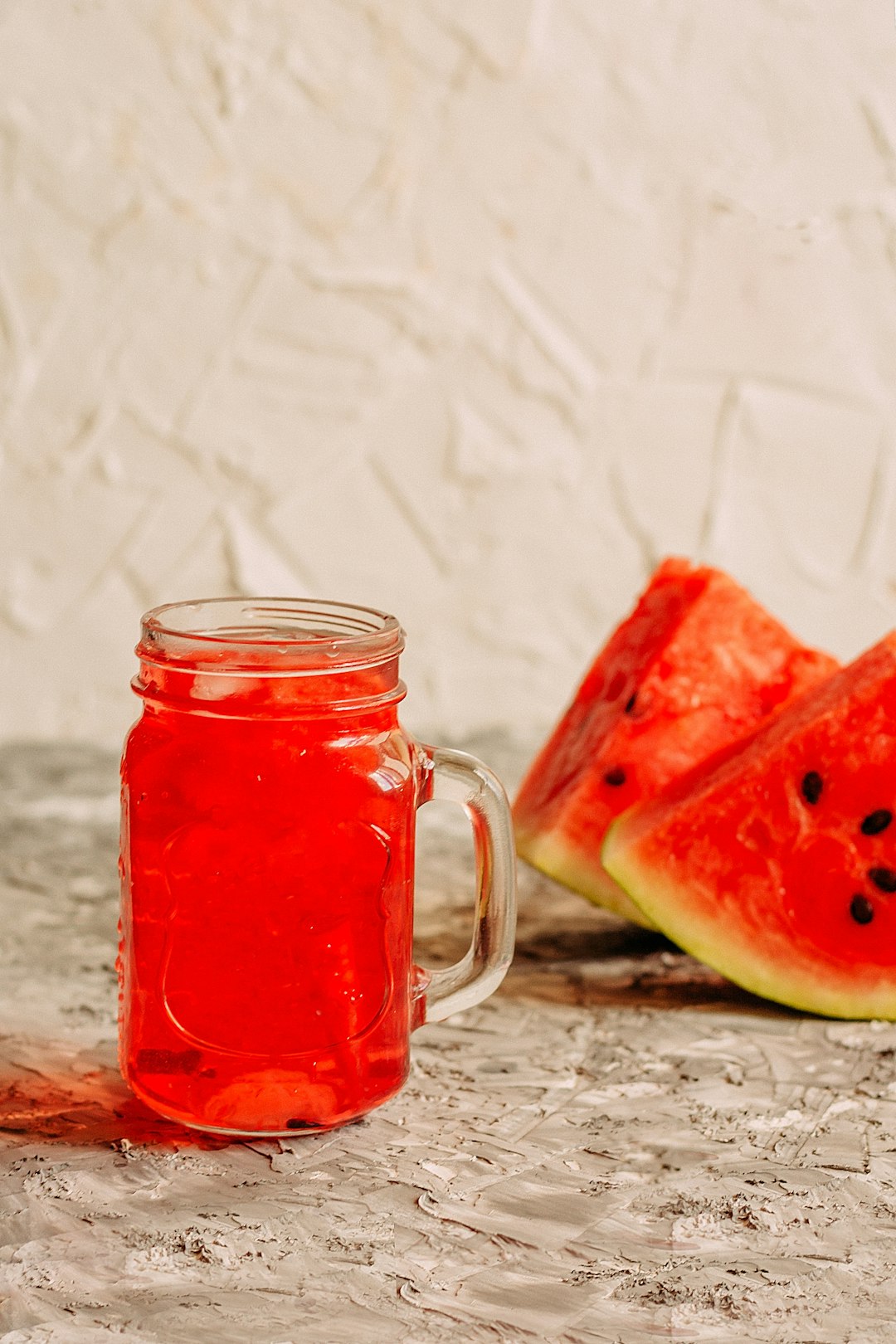 clear glass mug with red liquid inside