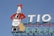 A rooftop billboard against a clear blue sky features a stylized bottle dressed in a red jacket and hat, holding a guitar. The bottle advertises 'Gonzalez Byass Jerez' with the text 'Tio Pepe' on the label. Large letters spell out 'TIO SOL DE ANDA'.
