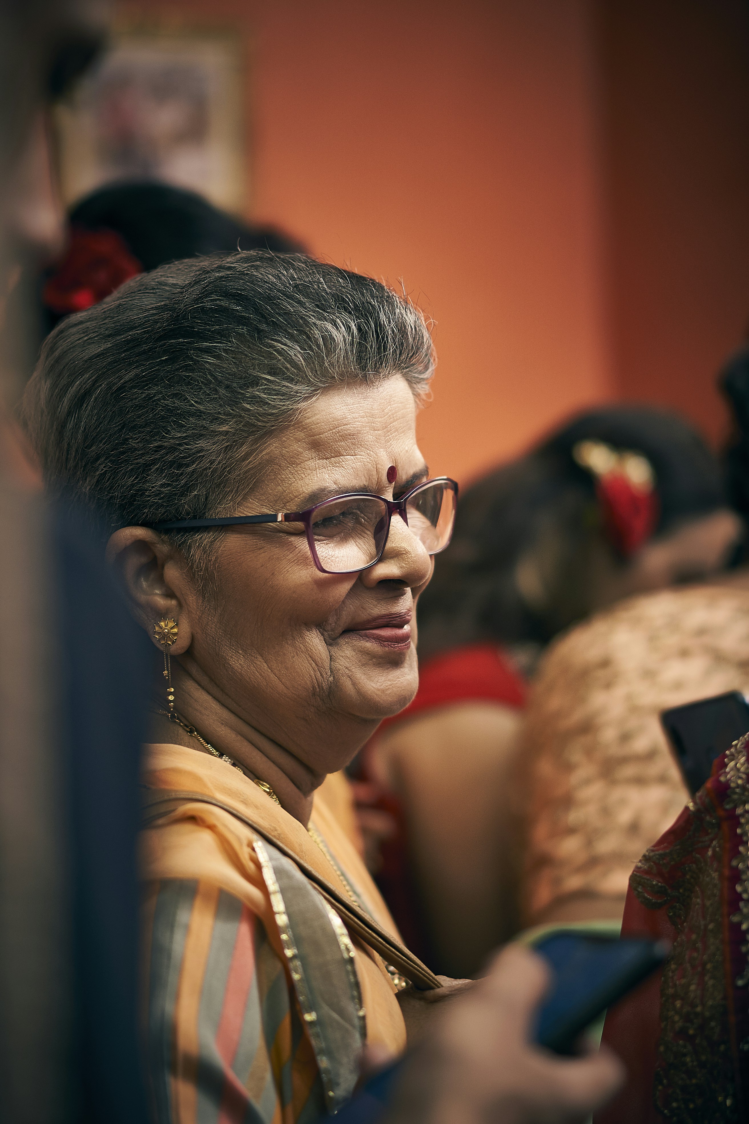 a woman with glasses is looking at her cell phone