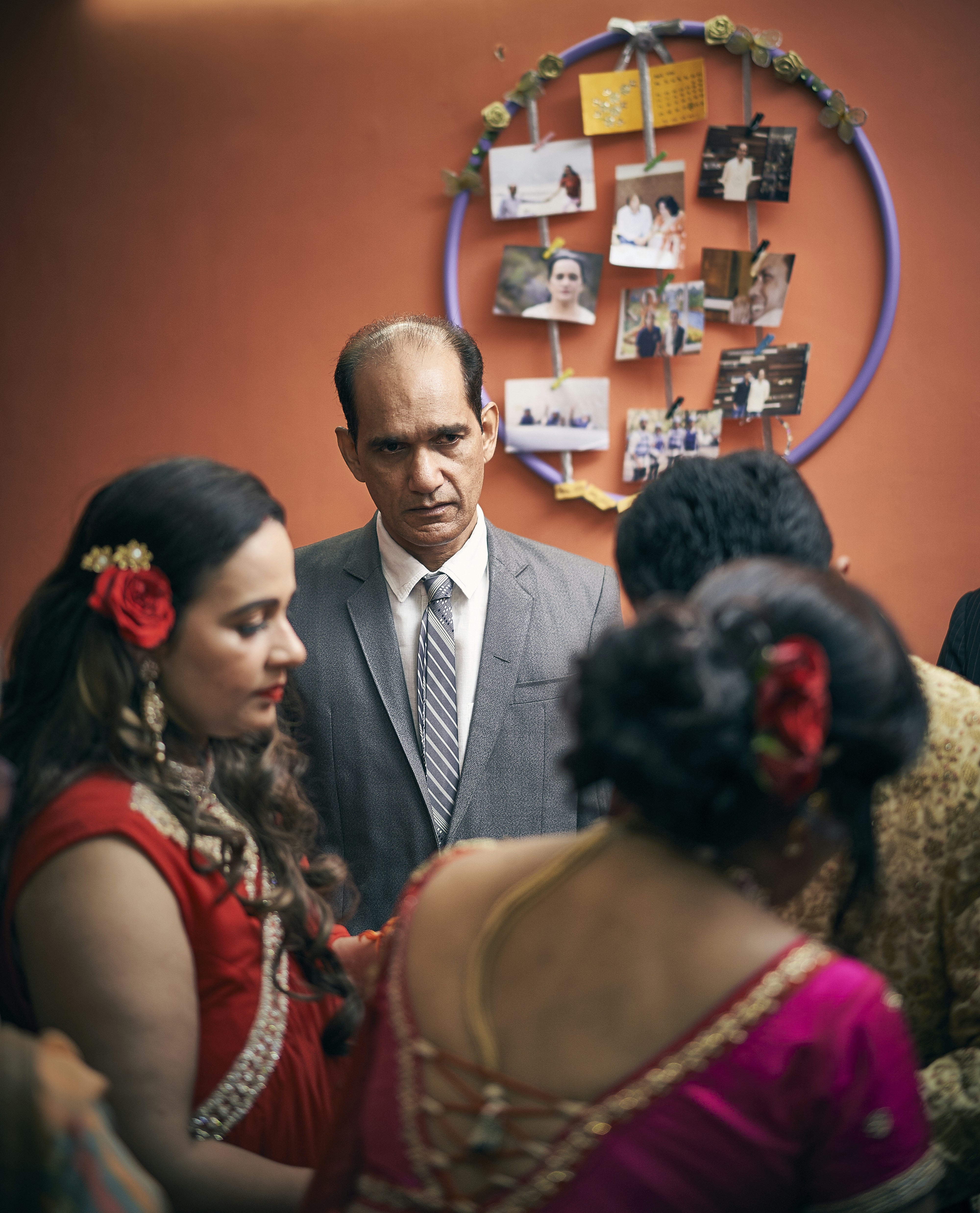 a man in a suit and tie talking to a group of women