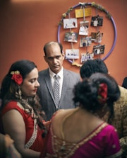 a man in a suit and tie talking to a group of women