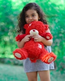 A child hugging a large, fluffy teddy bear.