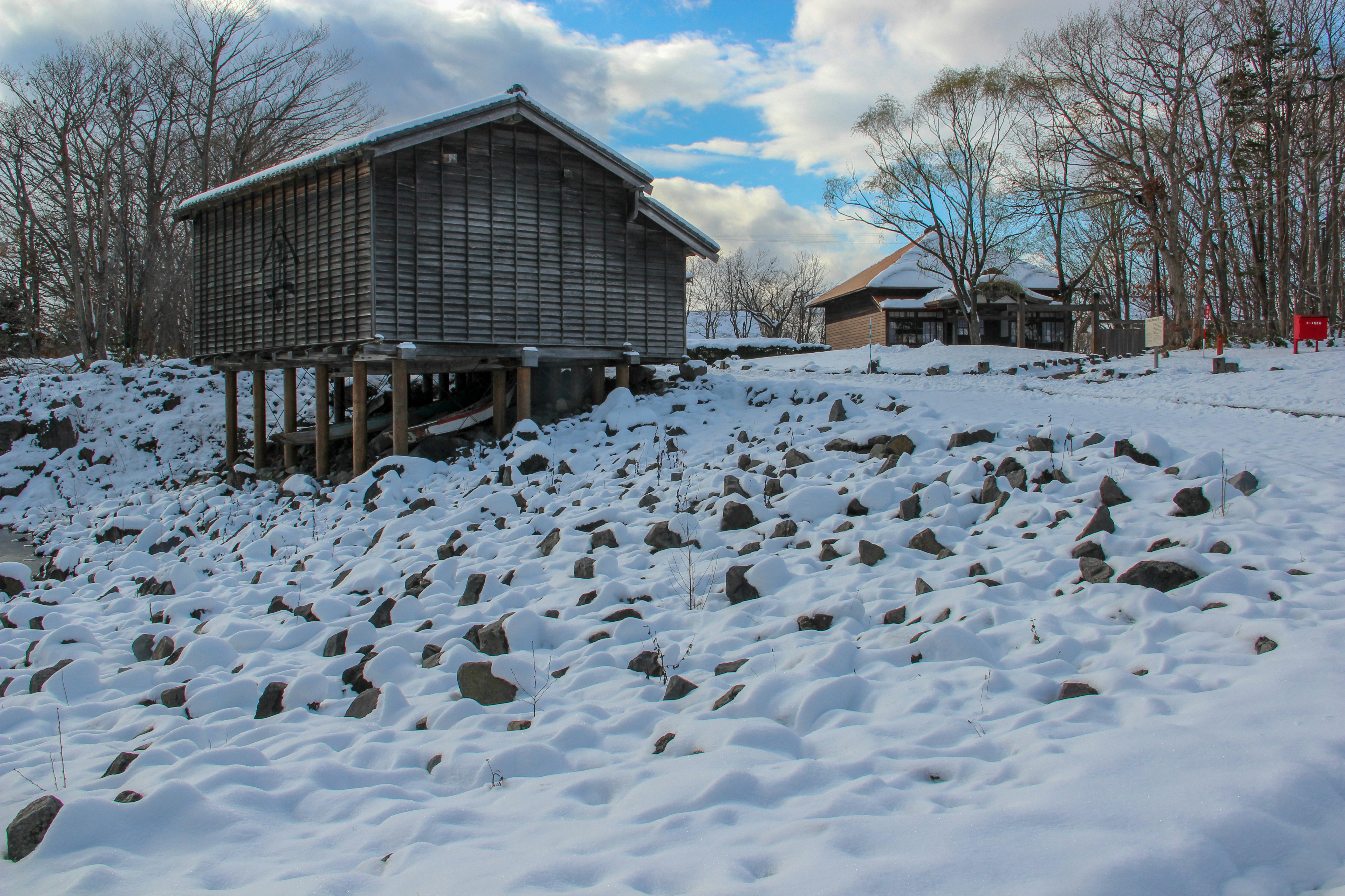 brown wooden house covered with snow during daytime