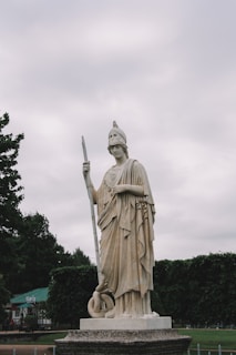 gold statue of man holding sword