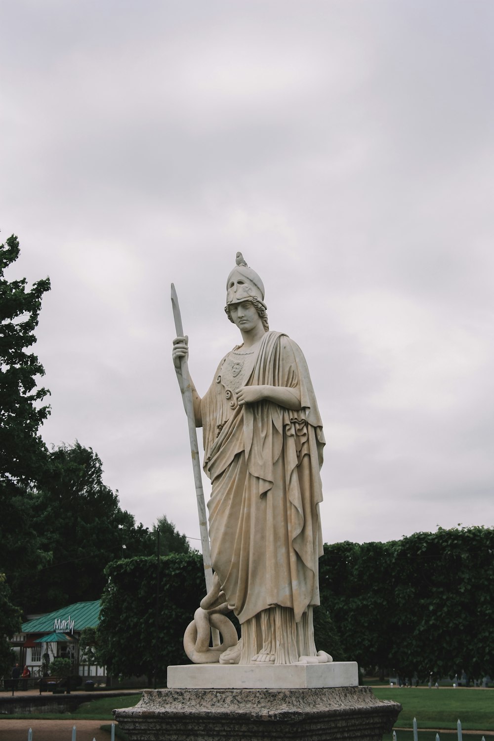 gold statue of man holding sword