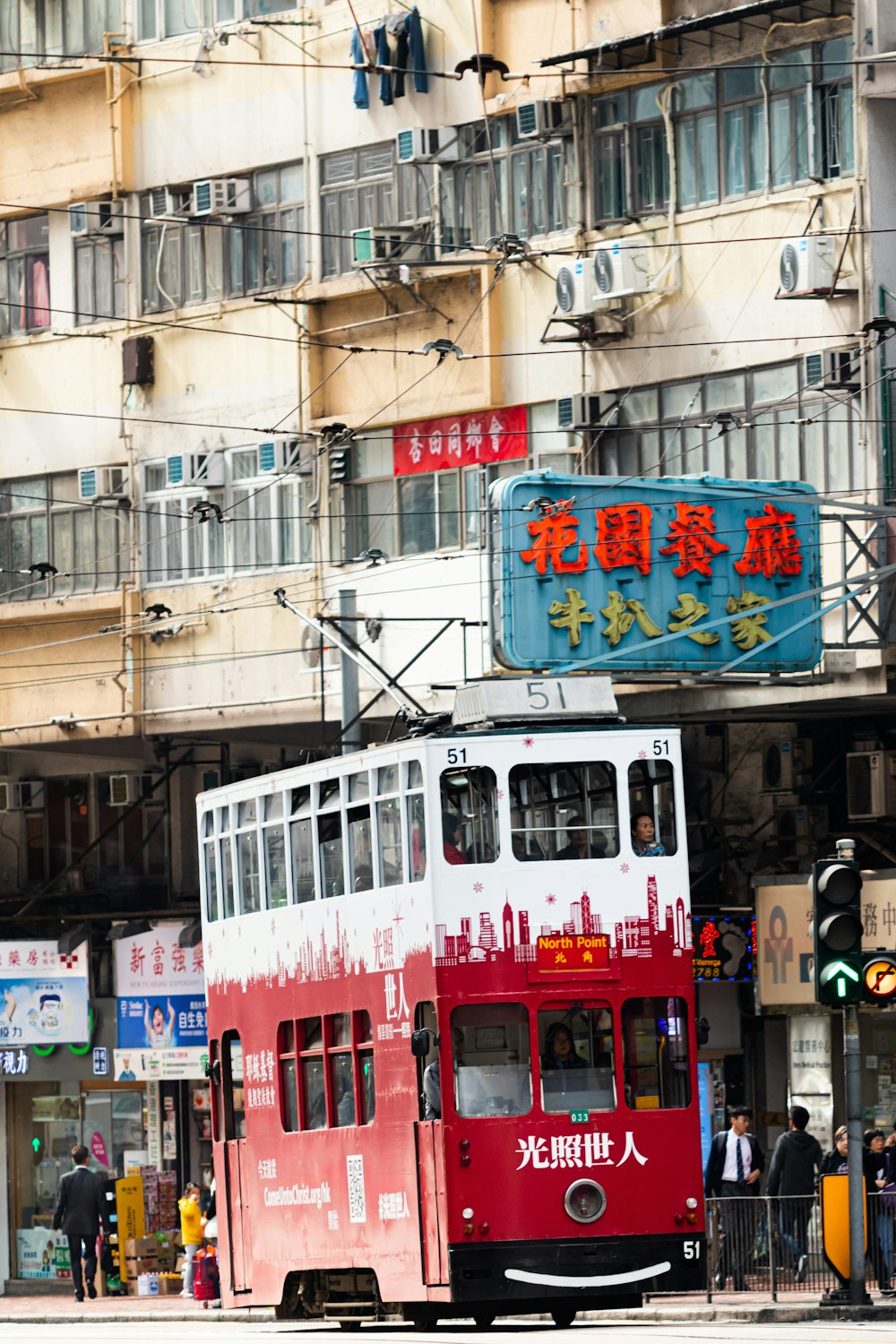 red and white bus on road during daytime