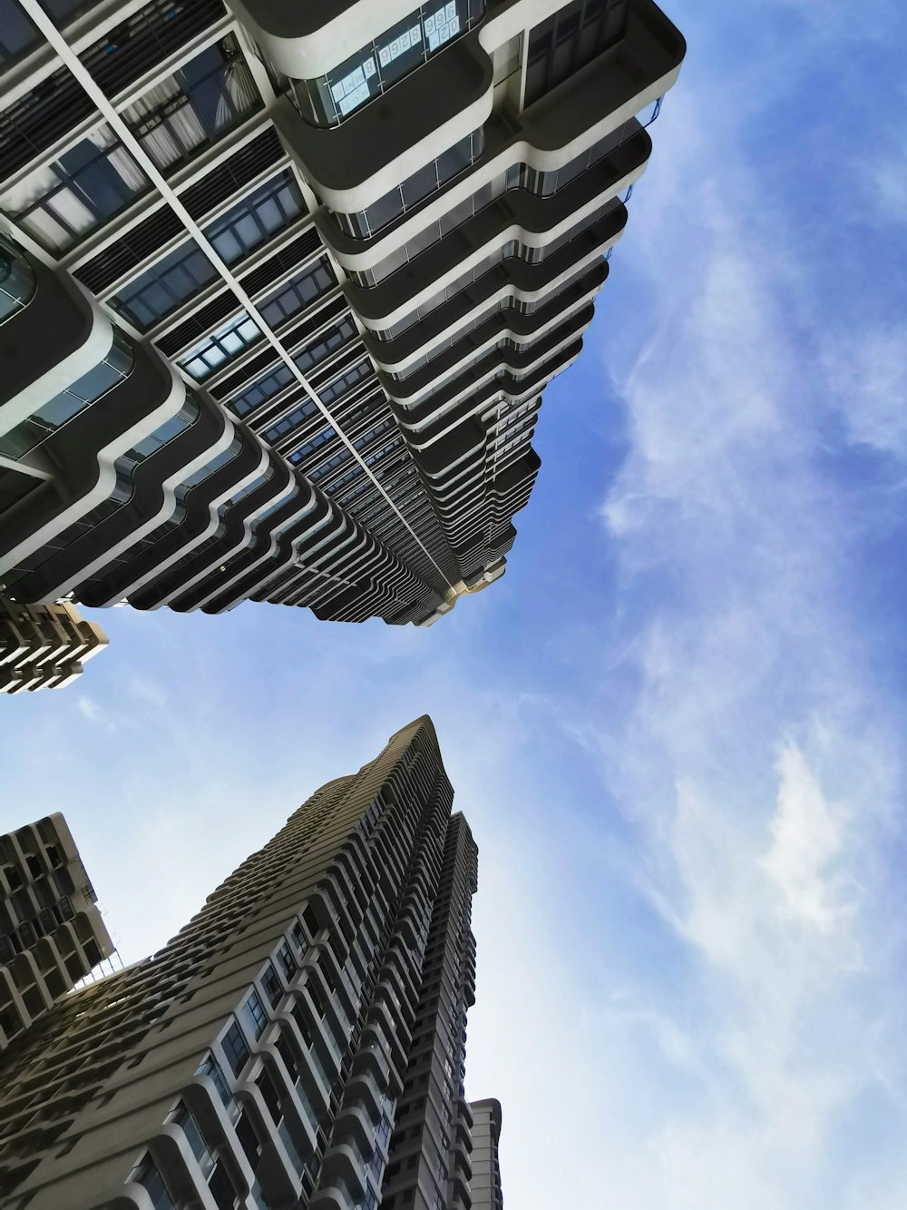 looking up at tall buildings in a city