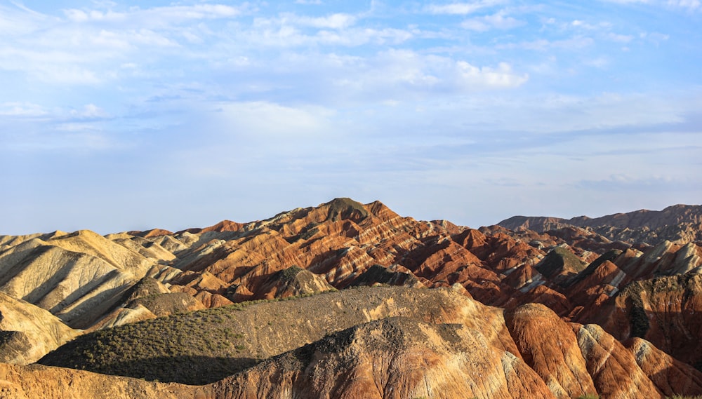 a view of a mountain range with a blue sky in the background