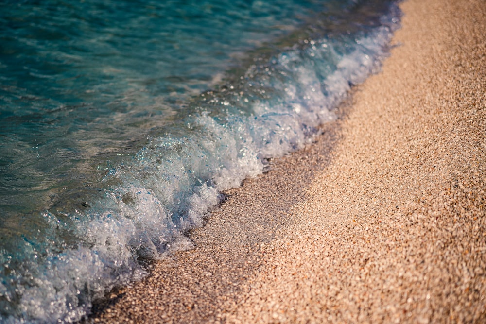 a close up of a wave on a beach