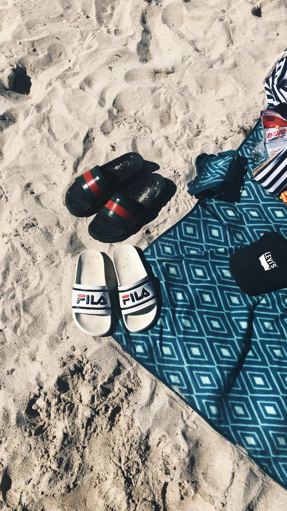 white and black flip flops on blue and white textile