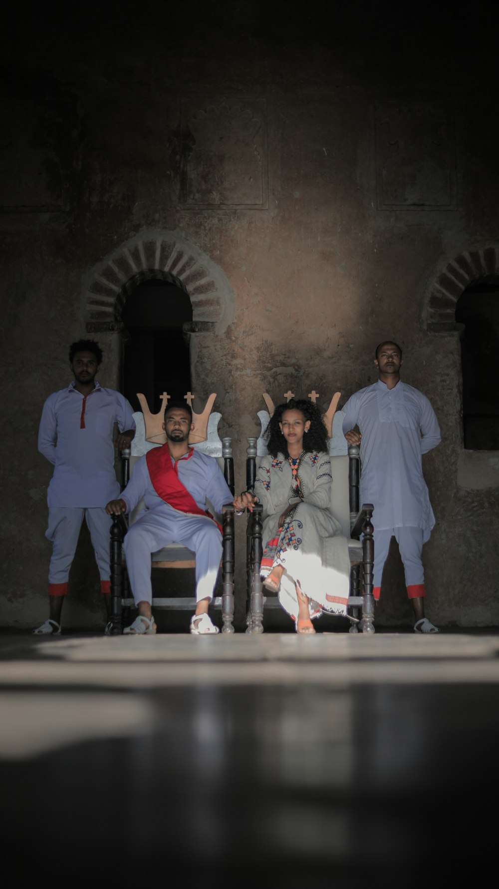 a group of people sitting in chairs in front of a building