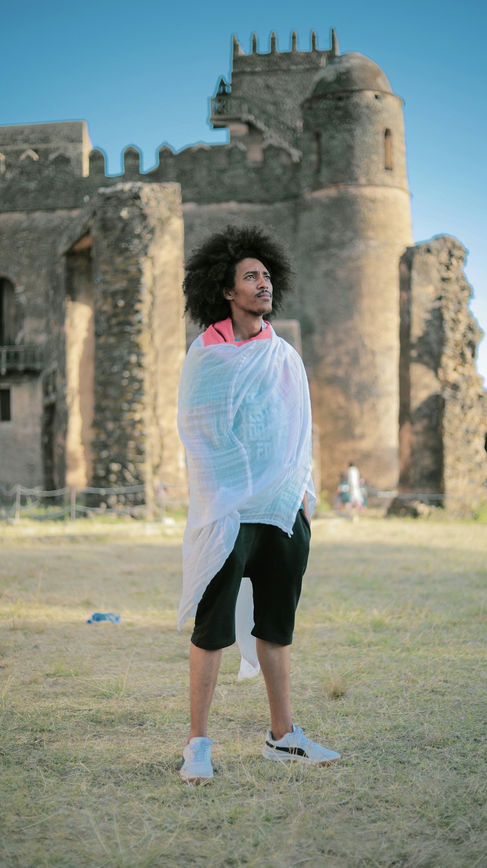 a person standing in a field with a frisbee