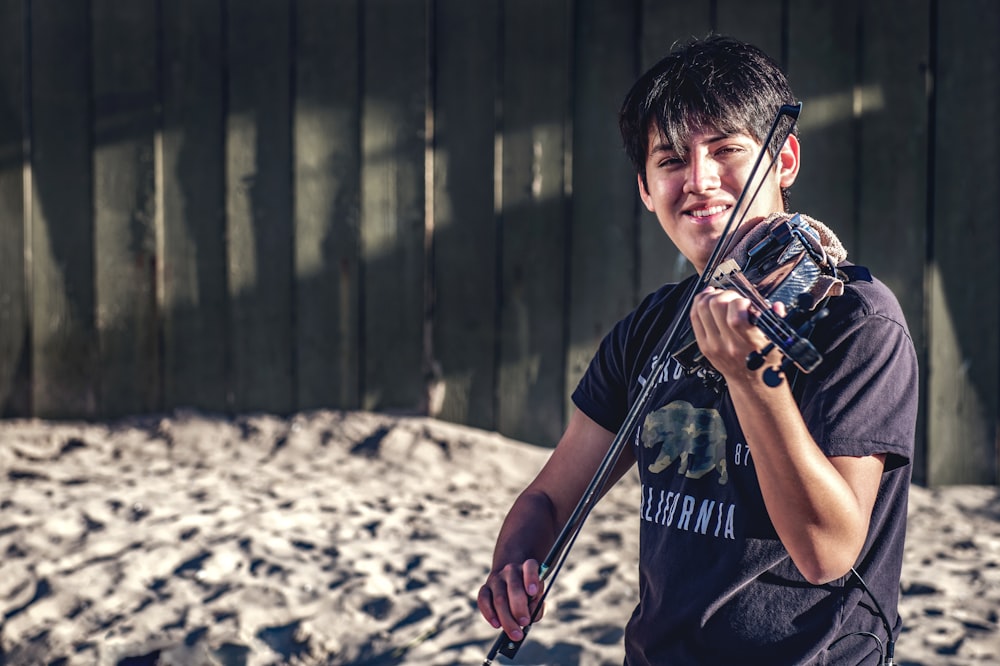 a young man holding a bow and arrow