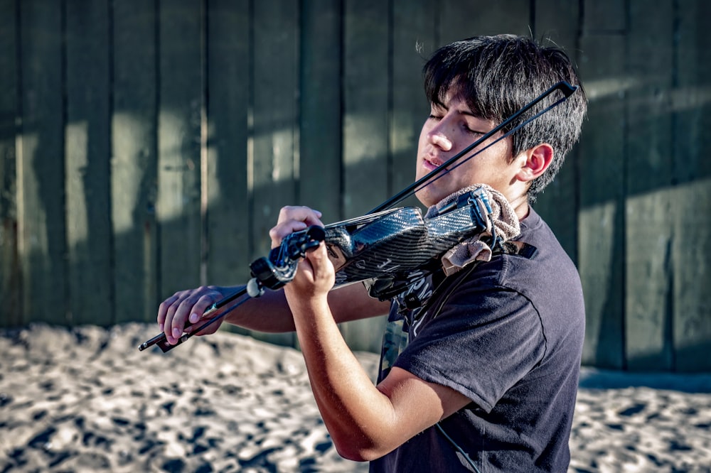 a young man holding a bow and arrow in his hands